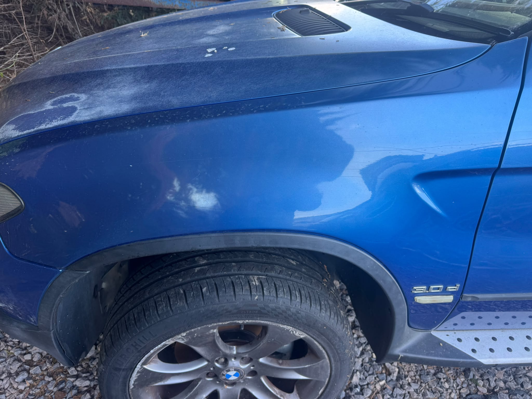 Blue BMW left fender
